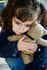 child holding teddy bear